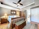 This primary bedroom offers a ceiling fan and hardwood floors, providing comfort and elegance at 16022 Westerham Dr, Tampa, FL 33647