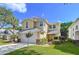 Charming two-story home with a two-car garage, manicured lawn and colorful landscaping at 16022 Westerham Dr, Tampa, FL 33647