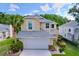 Charming yellow two-story home with a well-manicured lawn and attached two-car garage at 16022 Westerham Dr, Tampa, FL 33647
