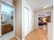 Hallway with hardwood floors leading to a bathroom and bedroom at 16022 Westerham Dr, Tampa, FL 33647
