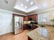 Beautiful kitchen features granite countertops, stainless steel appliances, and bright lighting at 16022 Westerham Dr, Tampa, FL 33647