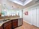Kitchen sink with granite countertops and stainless steel appliances open to the Gathering room at 16022 Westerham Dr, Tampa, FL 33647