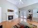Living room with hardwood floors, a fireplace, built in shelving and French doors leading to the patio at 16022 Westerham Dr, Tampa, FL 33647
