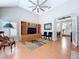 Bright living room with wood floors, high ceilings, entertainment center, and French doors to other rooms at 16022 Westerham Dr, Tampa, FL 33647