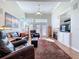 Cozy living room with high ceilings, a fireplace, plush seating, and ample natural light at 16022 Westerham Dr, Tampa, FL 33647