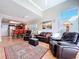 Bright living room features a soaring ceiling, plantation shutters, and stylish furniture at 16022 Westerham Dr, Tampa, FL 33647