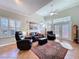 Spacious living room with high ceilings, tiled floor, comfortable seating, and bright windows at 16022 Westerham Dr, Tampa, FL 33647