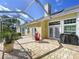 Covered patio with brick floor, sitting area and BBQ grill at 16022 Westerham Dr, Tampa, FL 33647