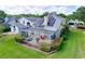 Stunning aerial view showcasing the screened lanai, solar panels, and well-manicured lawn at 16022 Westerham Dr, Tampa, FL 33647