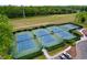 Tennis courts offering well-lit courts and convenient parking, surrounded by trees at 16022 Westerham Dr, Tampa, FL 33647