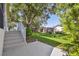 Expansive backyard featuring lush greenery, mature trees, and an inviting patio area perfect for outdoor entertaining at 18109 Tiverton Ct, Hudson, FL 34667
