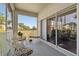 Enjoy outdoor living on this screened balcony with comfortable seating and views of the surrounding landscape at 18109 Tiverton Ct, Hudson, FL 34667