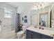 Well-lit bathroom with a shower-tub combination, vanity with ample storage, and tasteful decor for a relaxing experience at 18109 Tiverton Ct, Hudson, FL 34667