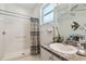 Updated bathroom with walk-in shower and granite counters providing a luxurious experience at 18109 Tiverton Ct, Hudson, FL 34667