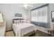 Cozy bedroom with natural light, ceiling fan, and a comfortable bed, perfect for relaxation and restful nights at 18109 Tiverton Ct, Hudson, FL 34667