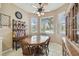 Sunlit eat-in kitchen featuring tile floors, a wooden table with chairs, and large windows at 18109 Tiverton Ct, Hudson, FL 34667