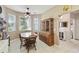 Charming eat-in kitchen featuring lots of natural light, tile floors, and classic wood table at 18109 Tiverton Ct, Hudson, FL 34667