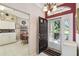 View of foyer showing front door, tile flooring, and eat-in kitchen with wood table at 18109 Tiverton Ct, Hudson, FL 34667