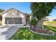 Beautiful house with a screened two-car garage, lovely landscaping, and a concrete driveway at 18109 Tiverton Ct, Hudson, FL 34667