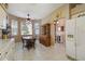 Bright kitchen with a bay window, dining table, china cabinet, and stainless steel refrigerator at 18109 Tiverton Ct, Hudson, FL 34667