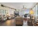 Bright living room with wood floors, floral seating, and a large window bringing in natural light at 18109 Tiverton Ct, Hudson, FL 34667