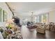 Cozy living room featuring hardwood floors, a ceiling fan, and sliding glass doors to a balcony at 18109 Tiverton Ct, Hudson, FL 34667