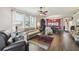 Open concept living room boasts wood-style floors, bright windows, and adjacent dining area at 18109 Tiverton Ct, Hudson, FL 34667