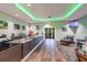 Lobby reception area features a dark wood counter, modern decor, and green ambient lighting at 18109 Tiverton Ct, Hudson, FL 34667