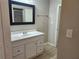 A well-lit bathroom featuring a vanity with a white sink, a mirror, and modern fixtures at 18232 Monteverde Dr, Spring Hill, FL 34610