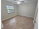 A bedroom with wood-look flooring and a window offering natural light at 18232 Monteverde Dr, Spring Hill, FL 34610