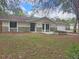 Charming single-story home featuring stone accents, neutral color palette, and mature trees at 18232 Monteverde Dr, Spring Hill, FL 34610