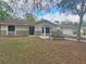 Charming single-story home featuring stone accents, neutral color palette, and mature trees at 18232 Monteverde Dr, Spring Hill, FL 34610