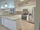 Well-lit kitchen with white cabinetry, granite countertops, and stainless steel appliances at 18232 Monteverde Dr, Spring Hill, FL 34610