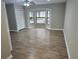 Spacious living room features natural lighting and wood-look flooring at 18232 Monteverde Dr, Spring Hill, FL 34610