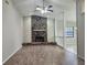 Spacious living room showcasing a brick fireplace, wood floors, and ample natural light at 18232 Monteverde Dr, Spring Hill, FL 34610