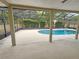 A screened-in pool area features ample space, providing an ideal setting for relaxation and leisure at 18232 Monteverde Dr, Spring Hill, FL 34610