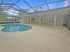 Open-air patio leads to a screened-in pool and beautiful landscaping, perfect for outdoor enjoyment and relaxation at 18232 Monteverde Dr, Spring Hill, FL 34610