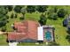 Aerial perspective showcasing the home, pool, and sprawling backyard with mature trees creating a private retreat at 22106 Garmisch Way, Brooksville, FL 34601