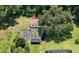 Aerial shot showcasing the home, lush greenery, custom garden, and surrounding wooded areas at 22106 Garmisch Way, Brooksville, FL 34601