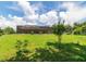 The house is located at the top of a hill overlooking the backyard, with a screened-in pool at 22106 Garmisch Way, Brooksville, FL 34601