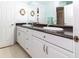 Bathroom featuring double sink vanity, granite countertops, and tile flooring at 22106 Garmisch Way, Brooksville, FL 34601