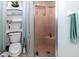 Bathroom featuring a shower, toilet, tile flooring, and storage shelving at 22106 Garmisch Way, Brooksville, FL 34601