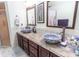 Bathroom featuring dual vessel sinks with granite countertops at 22106 Garmisch Way, Brooksville, FL 34601