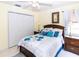 Bedroom with a bed, two side tables, ceiling fan, closet and tile floor at 22106 Garmisch Way, Brooksville, FL 34601