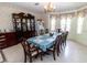 Dining room with chandelier, large windows, furniture and decor and beautiful china cabinet at 22106 Garmisch Way, Brooksville, FL 34601