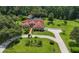 Beautifully landscaped home with a circular driveway and meticulously manicured lawn at 22106 Garmisch Way, Brooksville, FL 34601