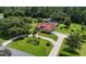 Charming home with a circular driveway, lush landscaping, and a well-maintained lawn at 22106 Garmisch Way, Brooksville, FL 34601