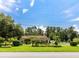 Exterior view of the house, surrounded by lush trees and well-manicured landscaping at 22106 Garmisch Way, Brooksville, FL 34601
