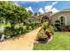 Charming home with a welcoming walkway, lush landscaping, and manicured lawn at 22106 Garmisch Way, Brooksville, FL 34601