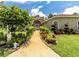 Charming home with a welcoming walkway, lush landscaping, and manicured lawn at 22106 Garmisch Way, Brooksville, FL 34601